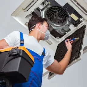 Air duct cleaning technician in Plainfield IL removing debris.